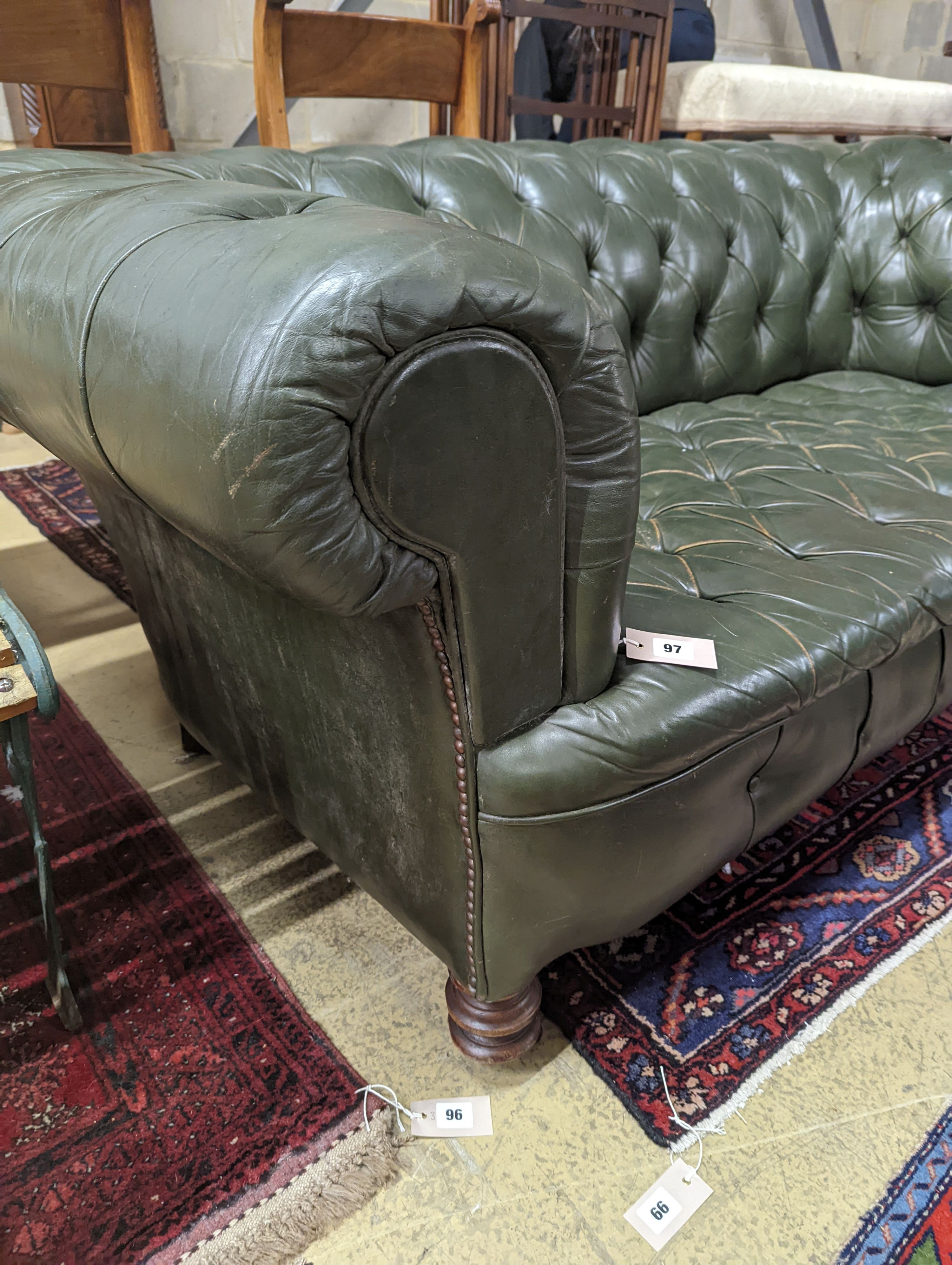 A late Victorian buttoned green leather Chesterfield settee, length 184cm, depth 82cm, height 70cm